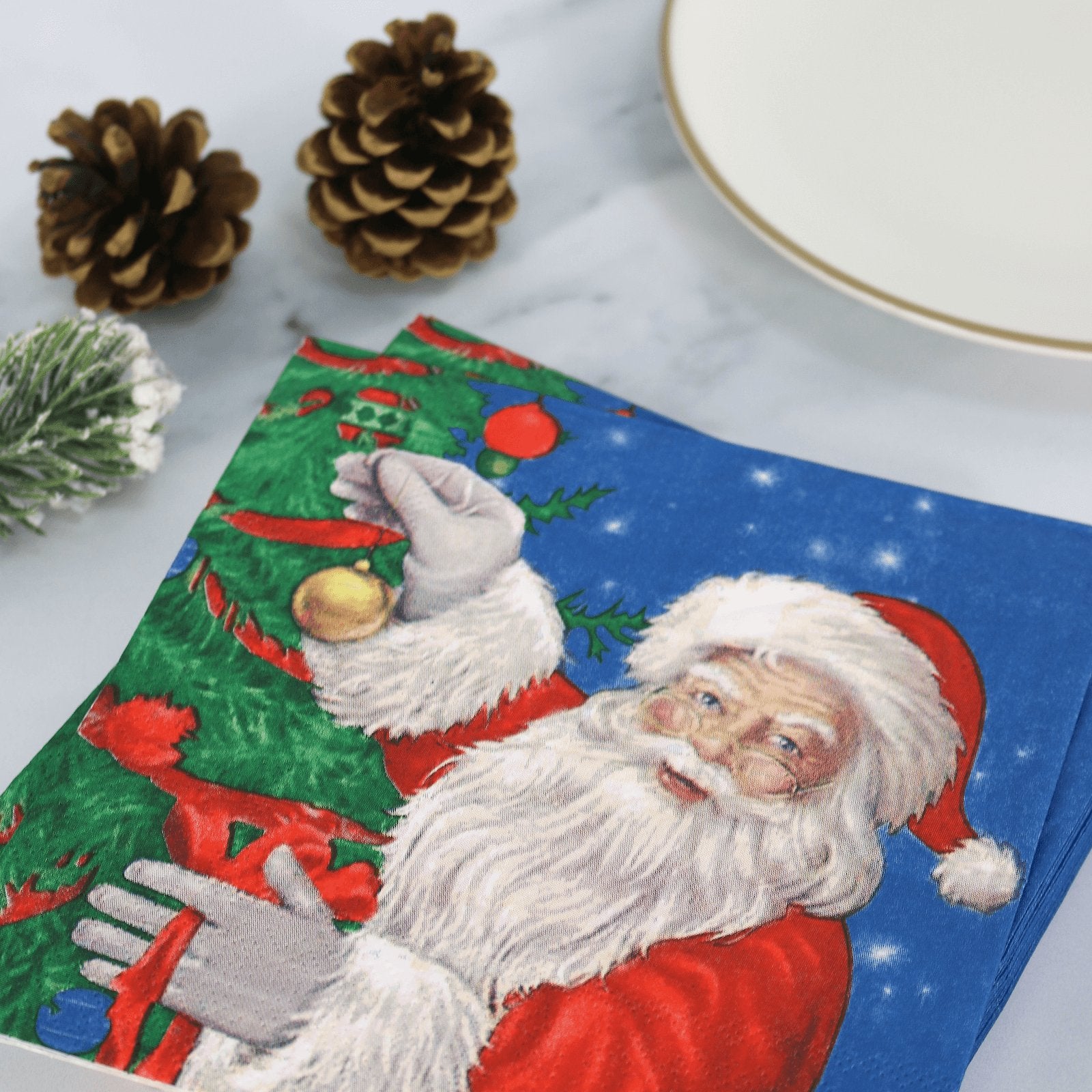 santa paper napkins on christmas table beside pine cones and garland